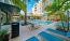 a pool with chairs and a television