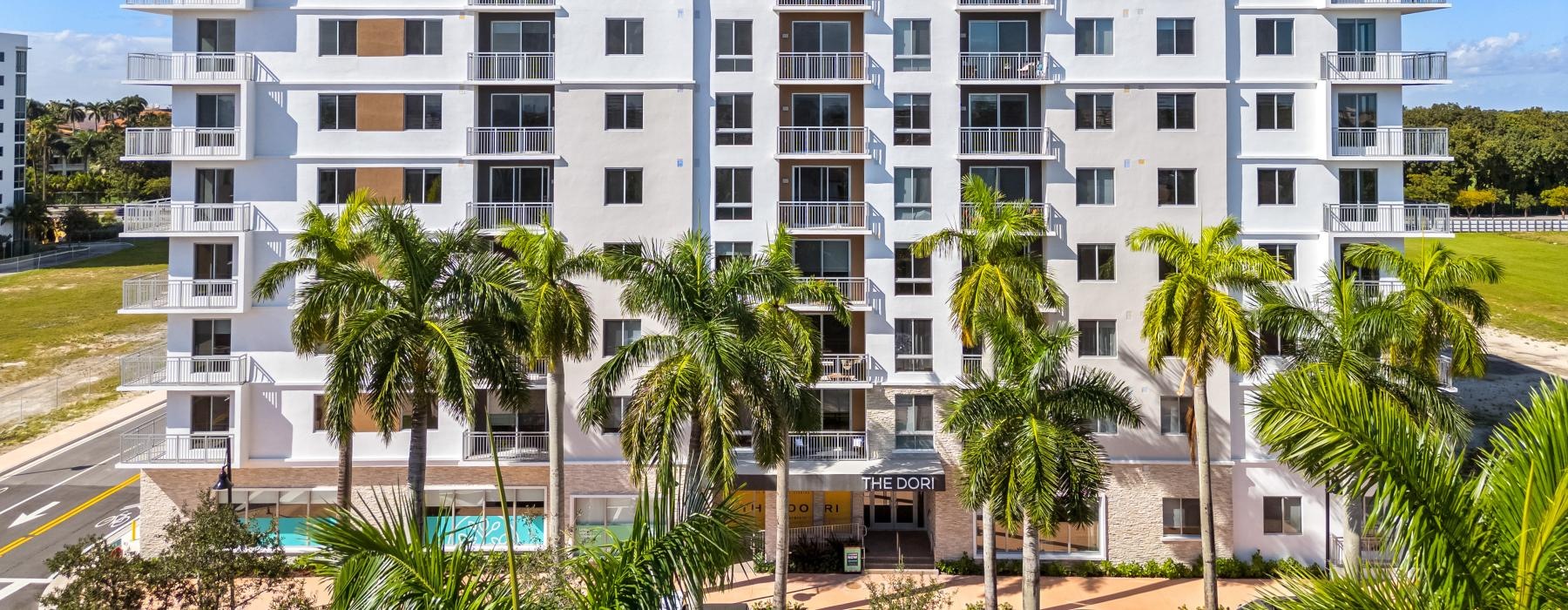 a building with palm trees in front